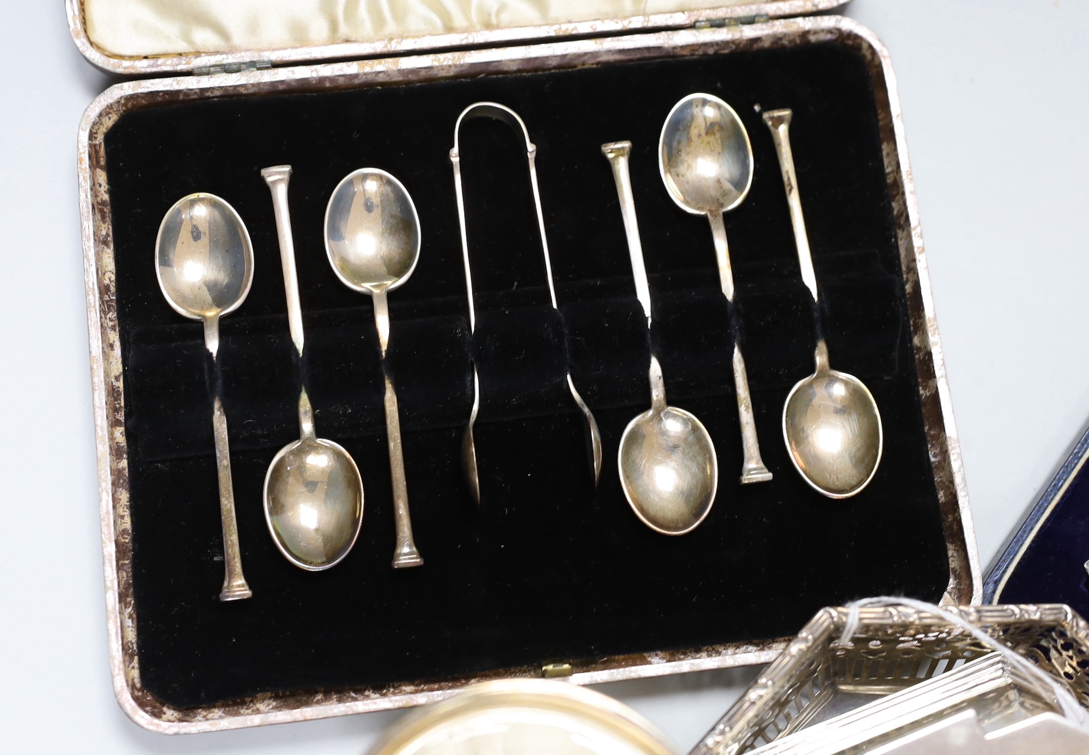 Assorted silver ware including two cased sets of six teaspoons, one with tongs, a christening mug, pierced sterling octagonal bowl, a Scottish silver quaich, inkwell, salt, three napkin rings, enamelled pill box, sifter